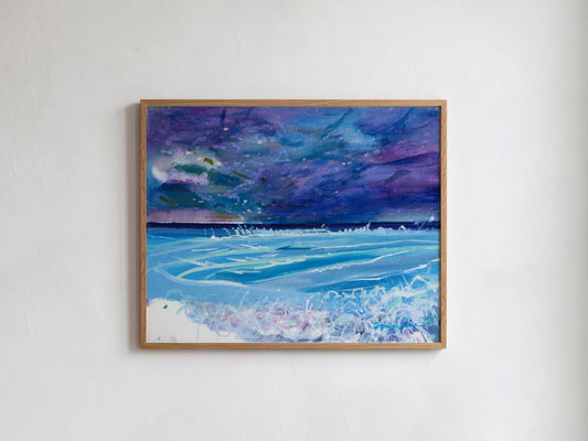 A framed painting of a stormy night sky over a blue ocean with white waves, hanging on a white textured wall.