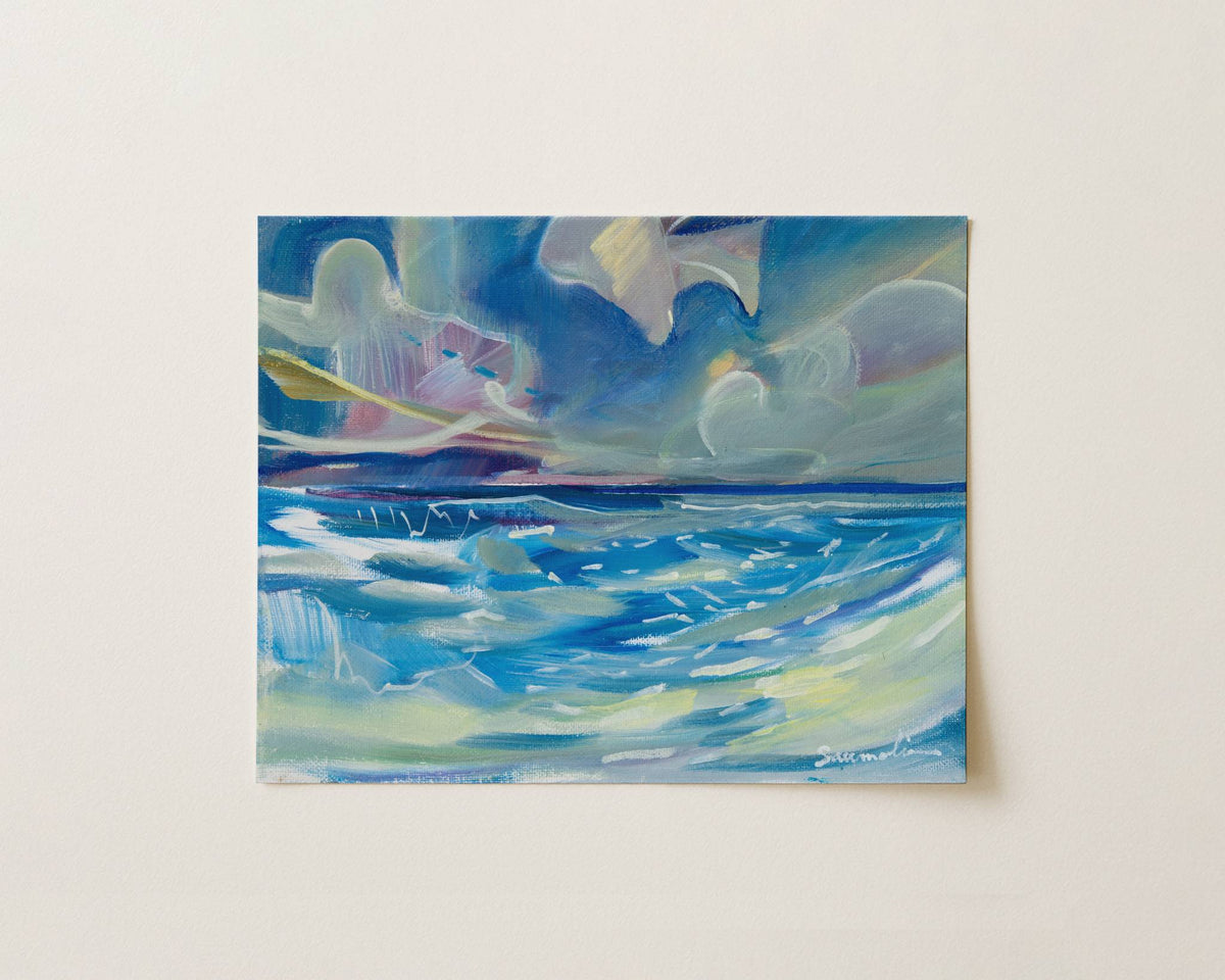 An abstract painting of an ocean scene with blue waves and a cloudy sky, displayed on a light beige wall.