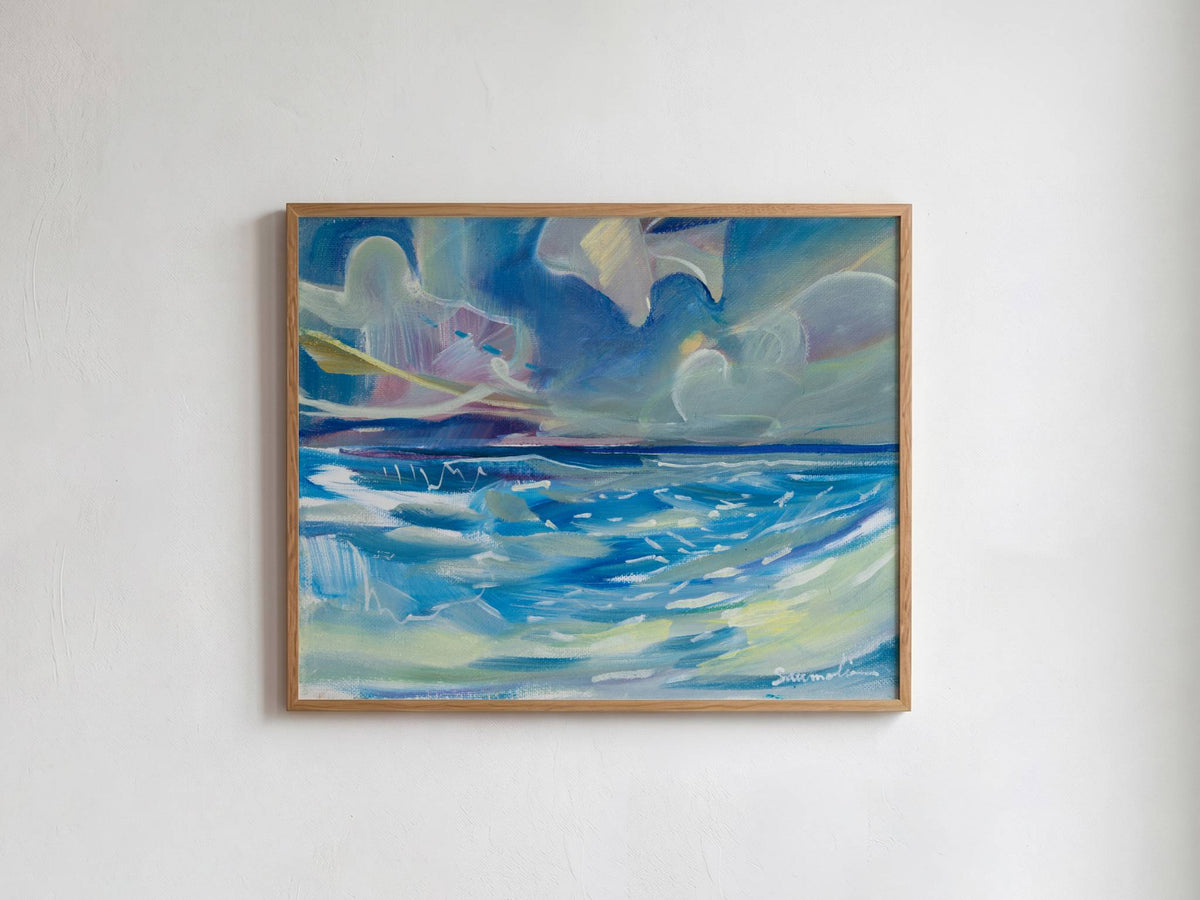 A framed abstract painting of a seascape with swirling blue, white, and gray waves under a cloudy sky, hung on a plain white wall.